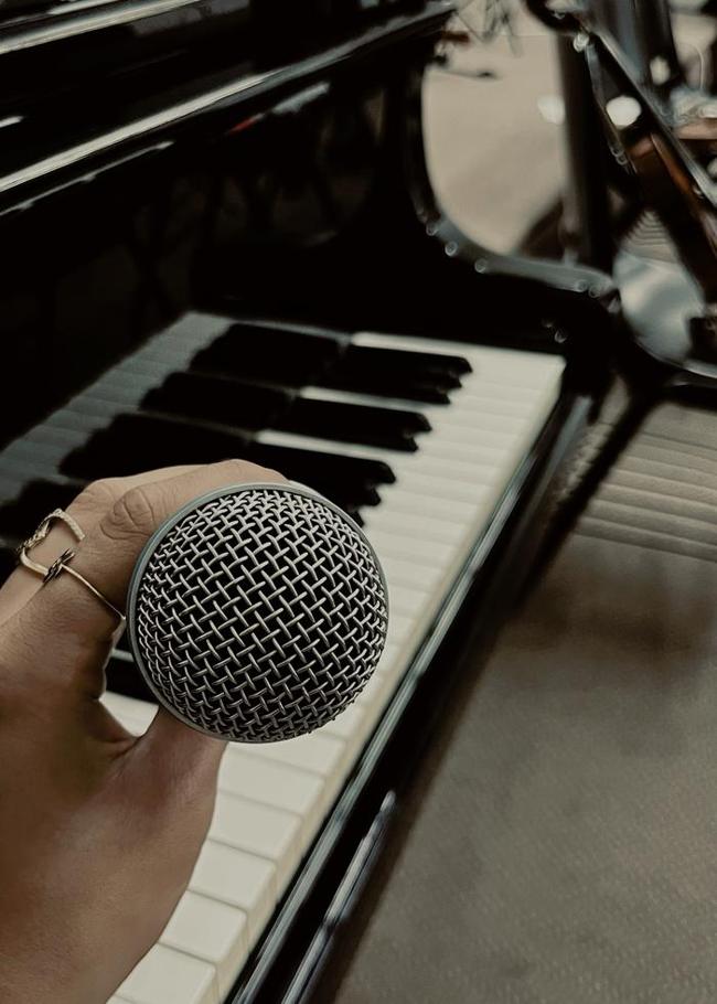 Microphone resting on a piano